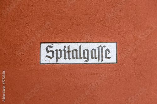 street name spitalgasse painted on a wall photo