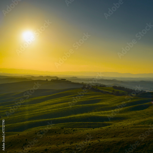 Tuscany, sunset rural landscape. Rolling hills and farmland.