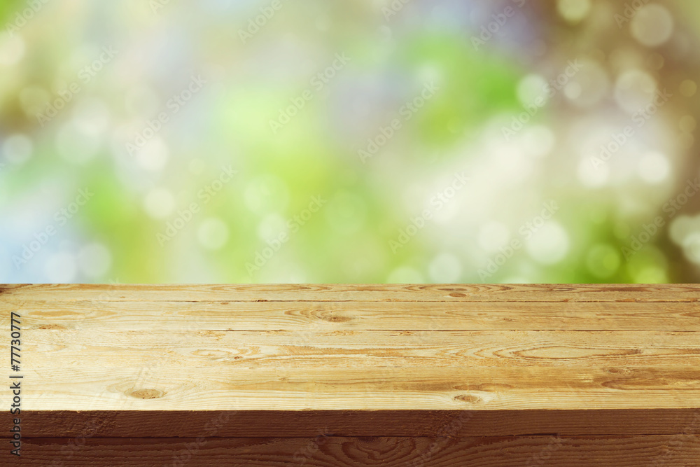 Old wooden deck table with spring bokeh background Old wooden deck table with spring bokeh background