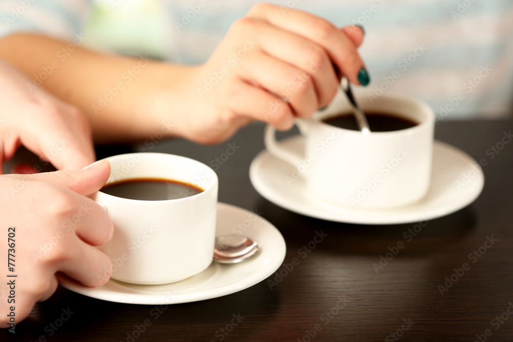 Two women with cups of coffee close up Two women with cups of coffee close up