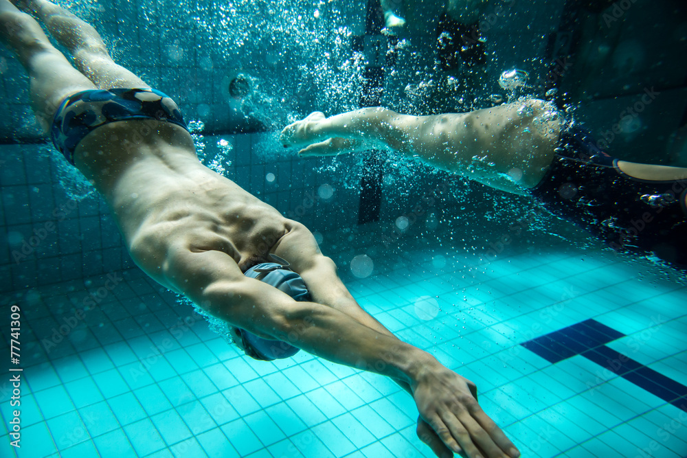 Swimmers at the swimming pool.Underwater photo. - obrazy, fototapety, plakaty 