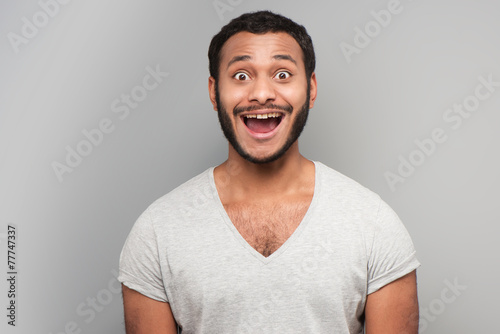 Mixed race man looking at camera cheerfully