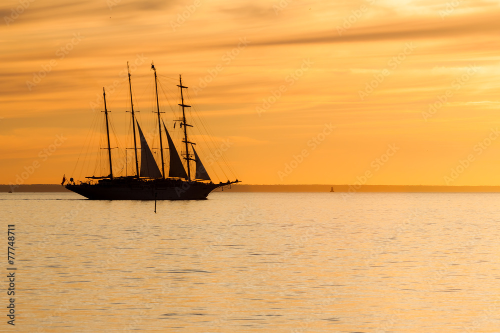 Old sail ship silhouette in sunset