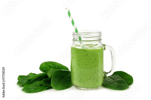 Healthy green smoothie with spinach in a jar mug isolated