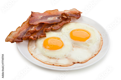 Plate with fried eggs, bacon isolated on white background