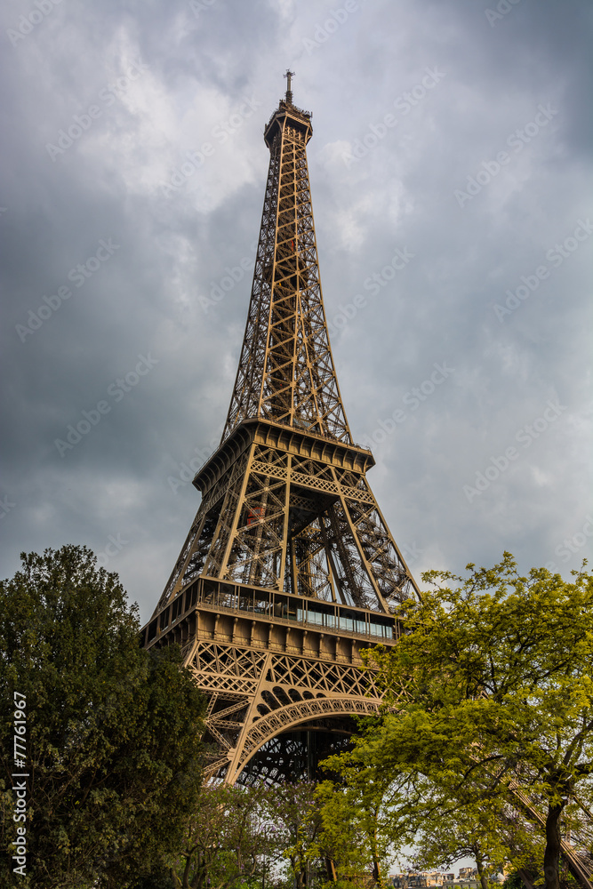 Eiffel Tower in Paris, France under a cloudy sky