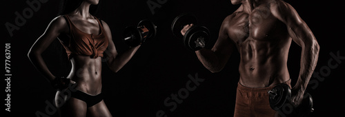 Bodybuilding. Strong man and a woman posing on a black backgroun