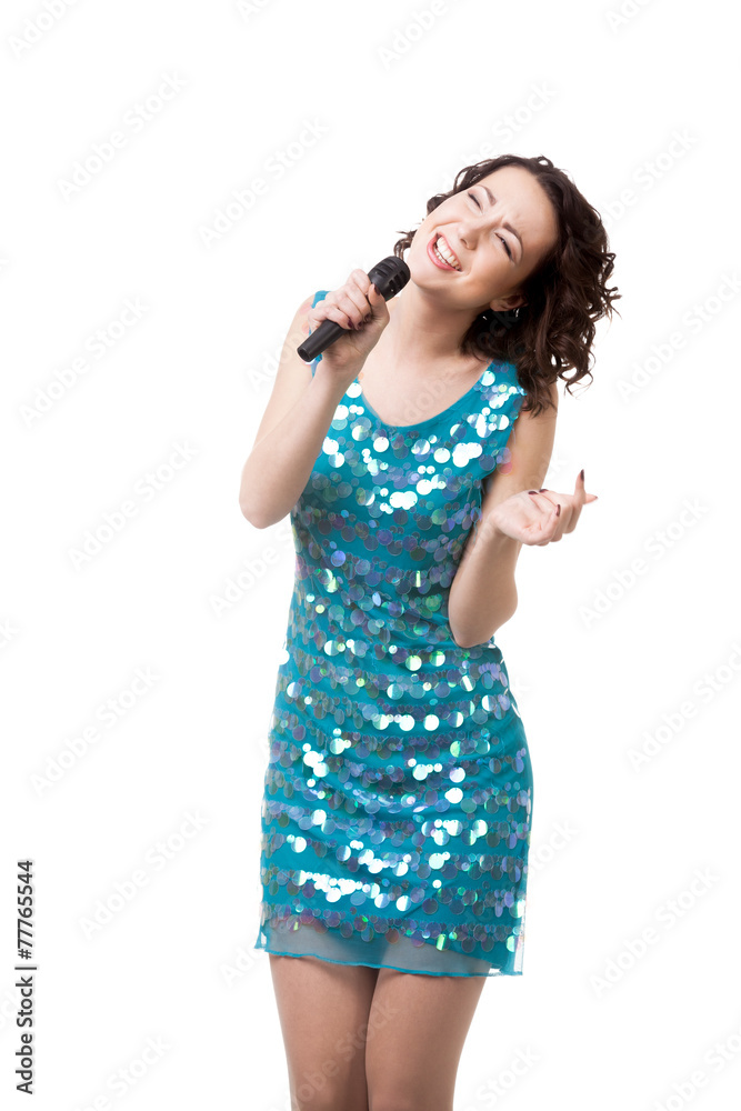 Excited young woman singing in short sparkling blue dress Excited young woman singing in short sparkling blue dress