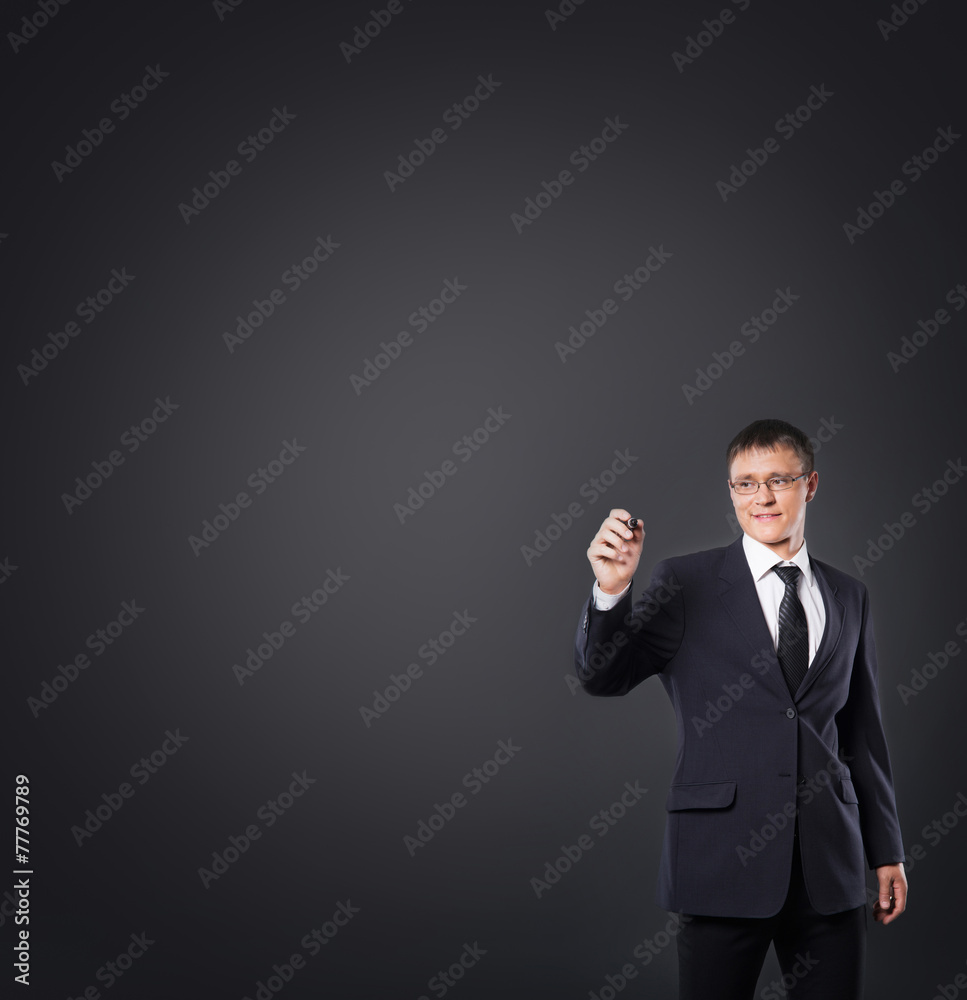 Successful and smart businessman writing imaginary text over gre Successful and smart businessman writing imaginary text over gre