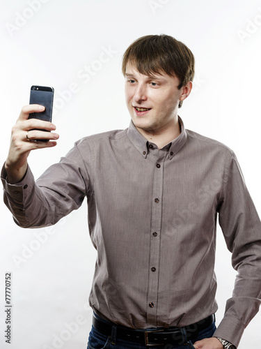 Young caucasian man making selfie photo