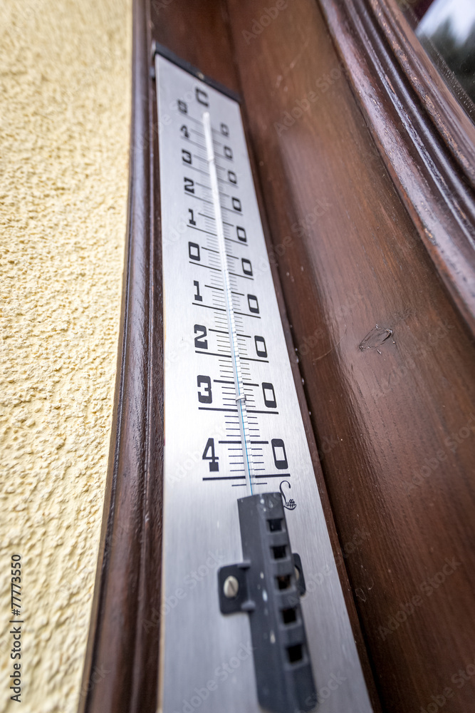 wide angle shot of outdoor thermometer showing negative temperat
