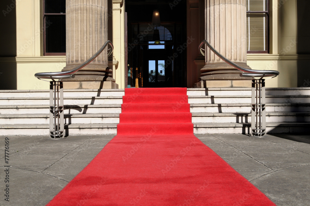 Red carpet at the entrance to a luxury hotel cinema or movie theater awards ceremony with steps stairs photo - obrazy, fototapety, plakaty 