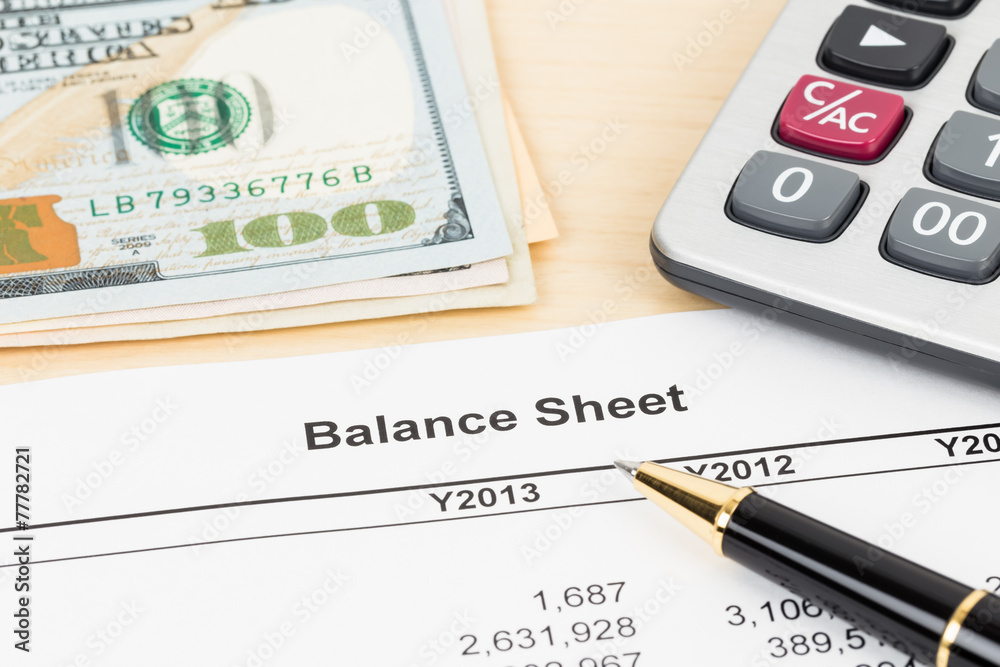 Balance sheet financial report with pen, and banknote Balance sheet financial report with pen, and banknote