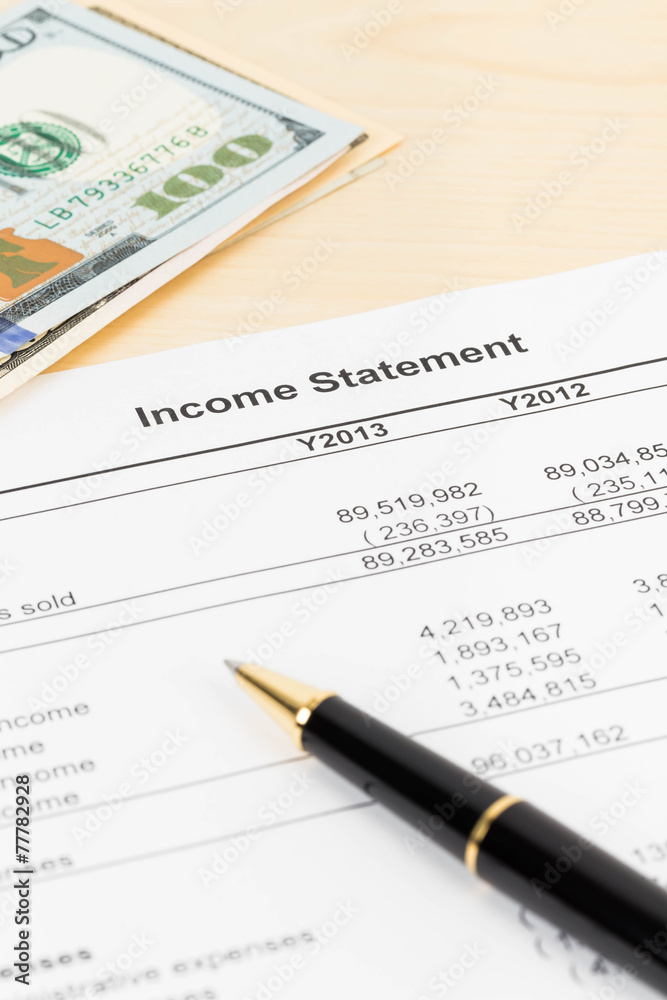 Income statement financial report with pen, and banknote Income statement financial report with pen, and banknote