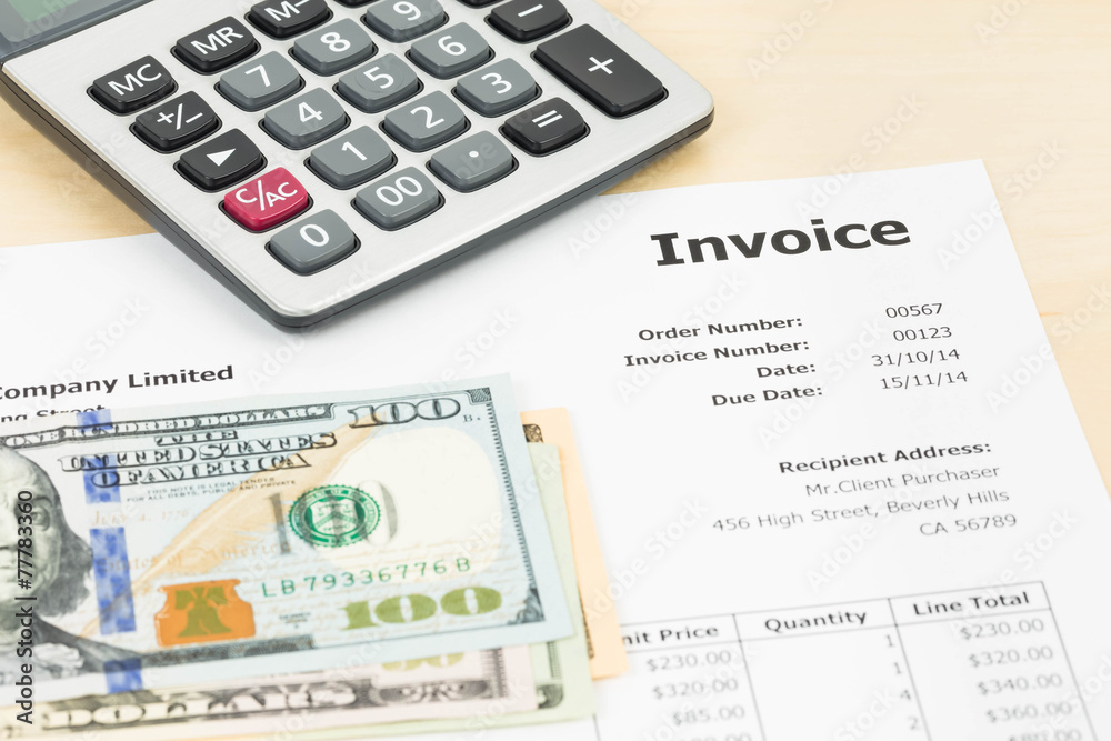 Invoice with calculator and dollar banknote