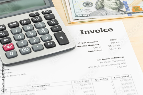 Invoice with calculator and dollar banknote