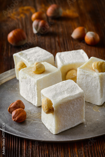 Eastern  tasty oriental sweets or Turkish delight with hazelnuts