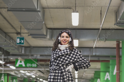 Beautiful young brunette posing in a parking garage