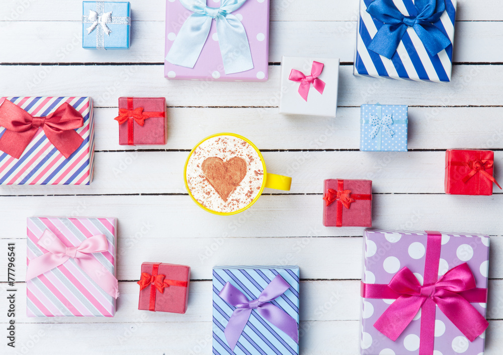 Fototapeta premium Cup of Cappuccino and gift boxes