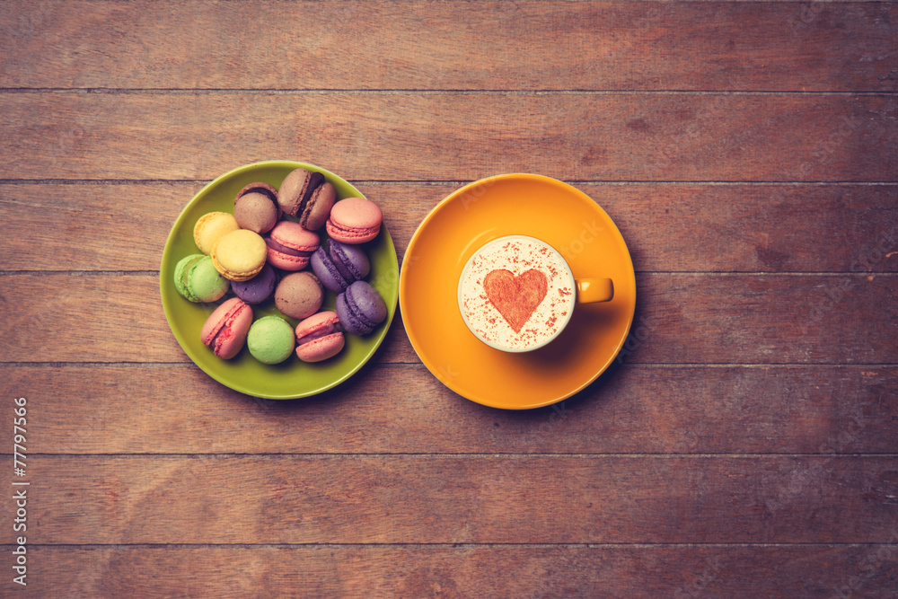 Cup and macarons on wooden background Cup and macarons on wooden background