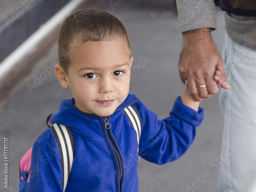 Child holding father's hand