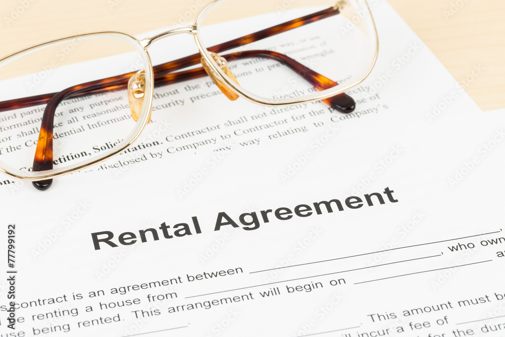 Rental agreement document with glasses Rental agreement document with glasses
