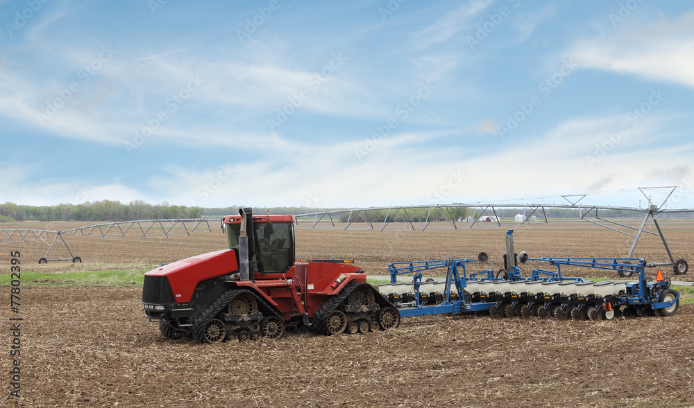 Fototapeta premium Red Farm Tractor and Planter