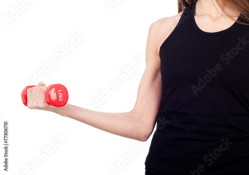 A woman holding a red dumbbell
