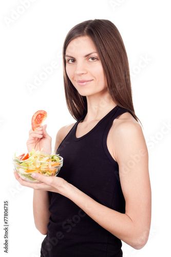 Hungry beautiful healthy woman holding salad on white background