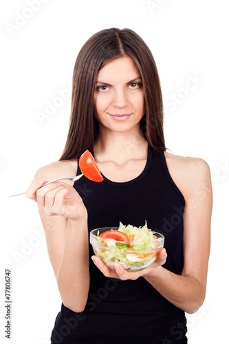 Hungry beautiful healthy woman holding salad on white background