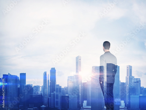 Double exposure of a businessman and megalopolis