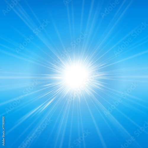 Intense sunlight and sunbeams in a clear blue sky