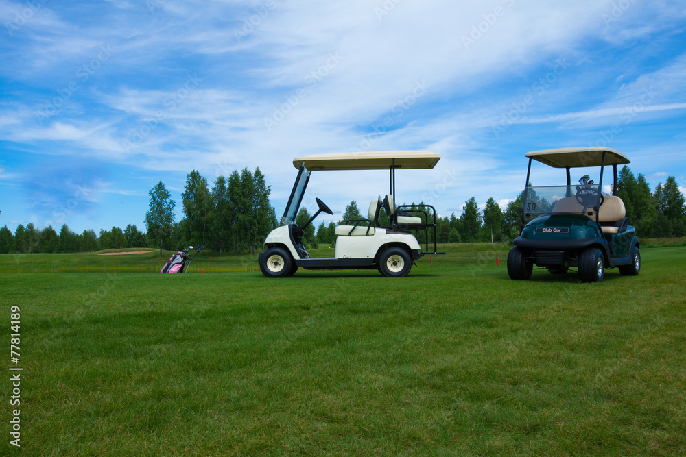 two golf carts on the golfe course in summer