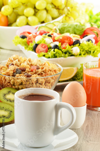 Breakfast with coffee, juice, croissant, salad, muesli and egg