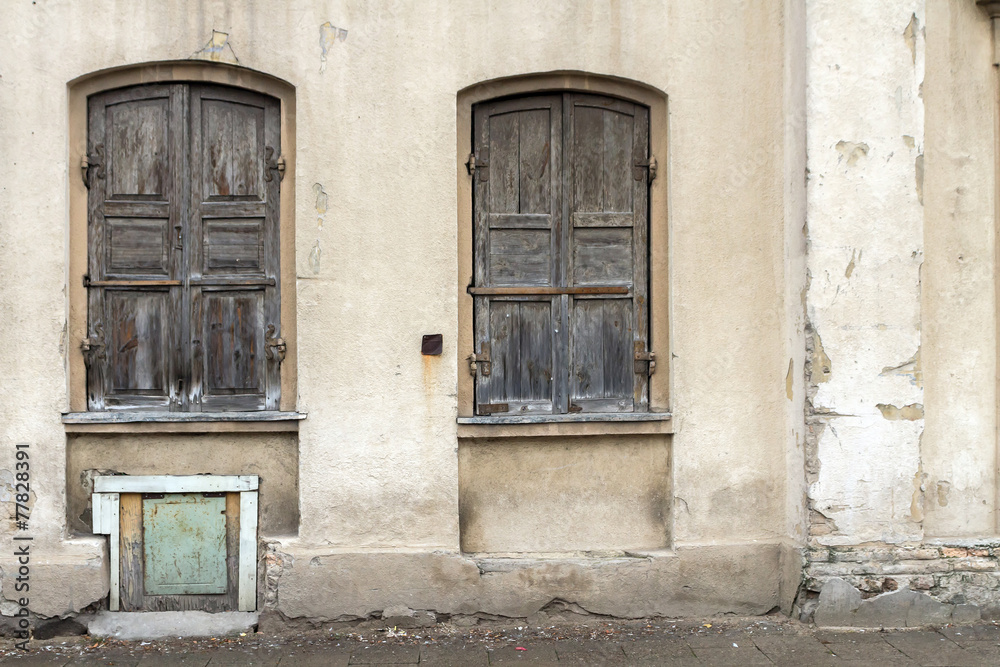 Two windows of the old house in Vilnius, shuttered