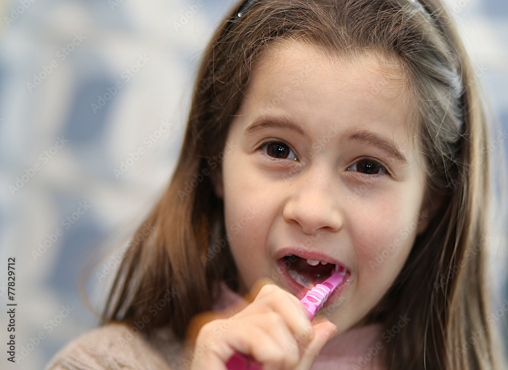 young girl without a tooth while brushing teeth in the bathroom young girl without a tooth while brushing teeth in the bathroom
