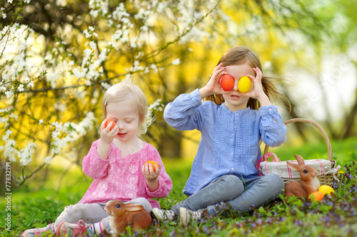 Two little girls playing in a garden on Easter