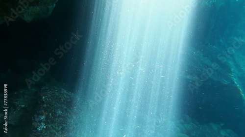 Sunbeams shining in an underwater cave