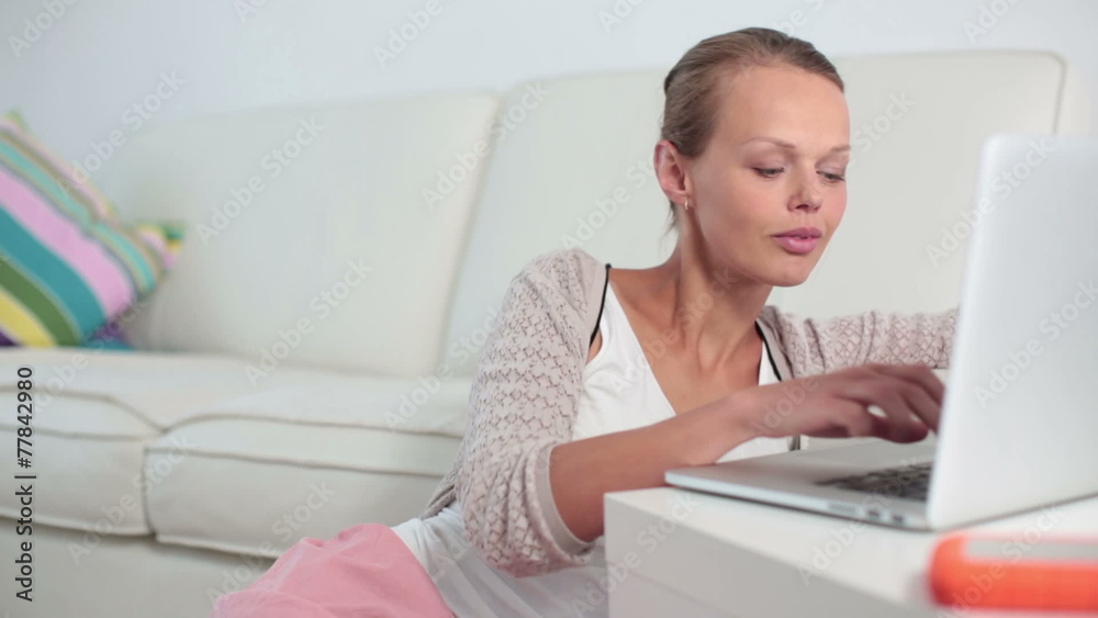 Young beautiful woman working on her computer at home Young beautiful woman working on her computer at home