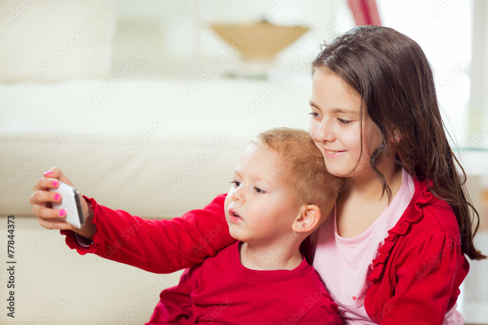 Happy brother and sister take pictures with telephone Happy brother and sister take pictures with telephone