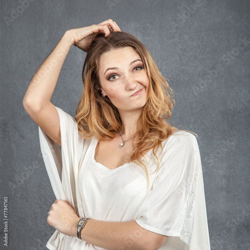 Puzzled woman with hands in her hair