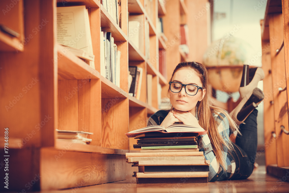 Woman student in college library Woman student in college library