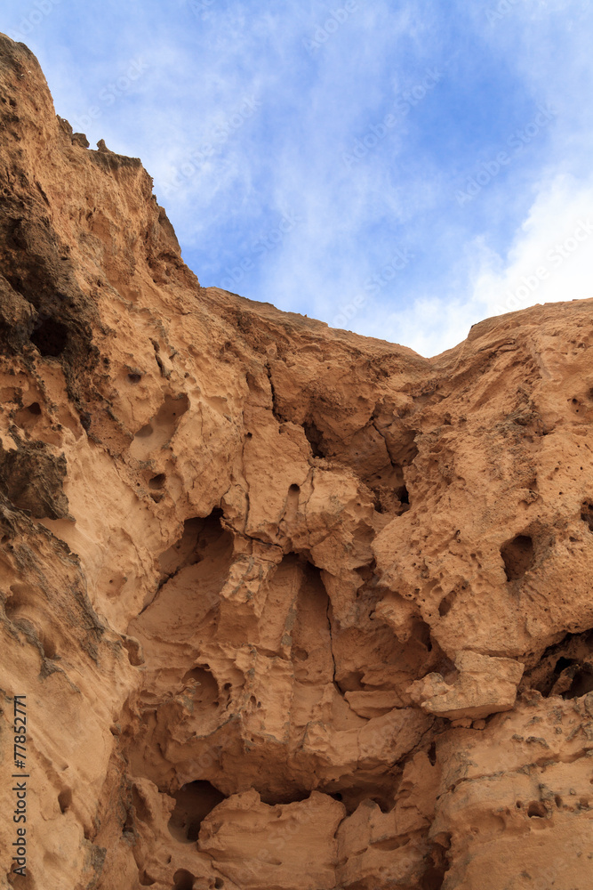 A rock wall against a blue sky