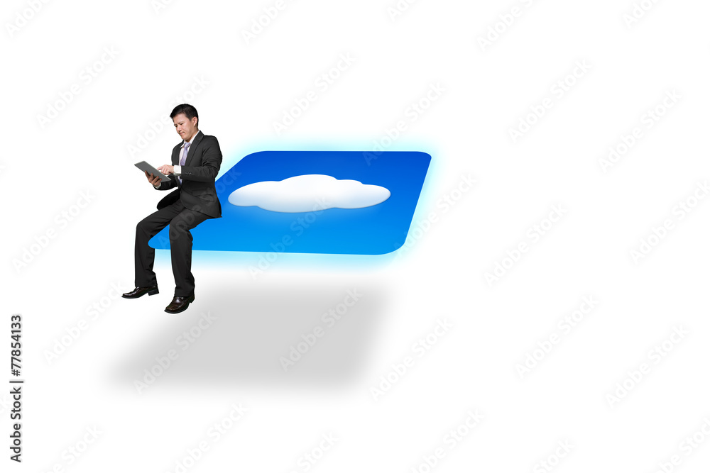 Businessman using tablet sitting on cloud icon with white backgr