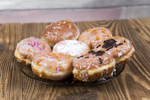 Jummy donuts on wooden table