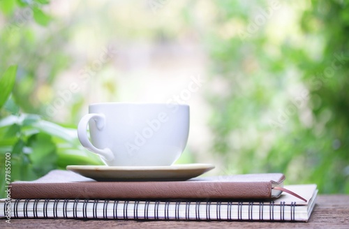 Notebook and coffee on wooden table