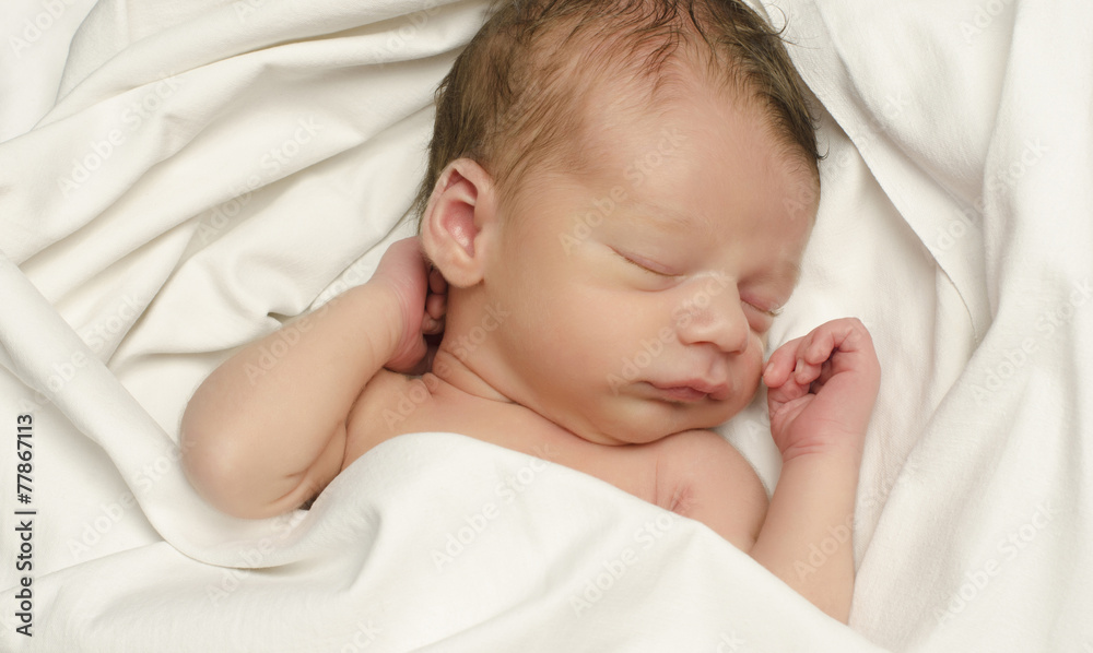 New born baby boy sleeping. Baby taking a nap in white sheets. New born baby boy sleeping. Baby taking a nap in white sheets.