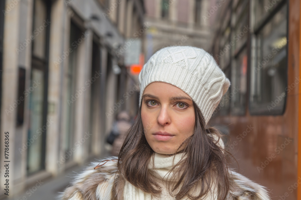 Beautiful young woman posing in the city streets
