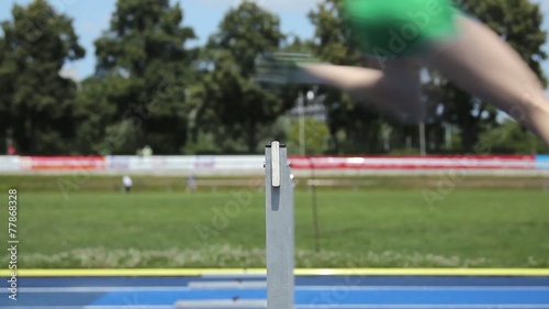 Female hurdle runners side view