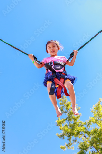 Adorable girl bungee jumping